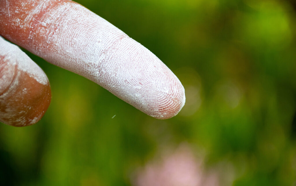 Fingerprint of chalk photographed to assimilate the footprint of our sustainable climbing chalk solution