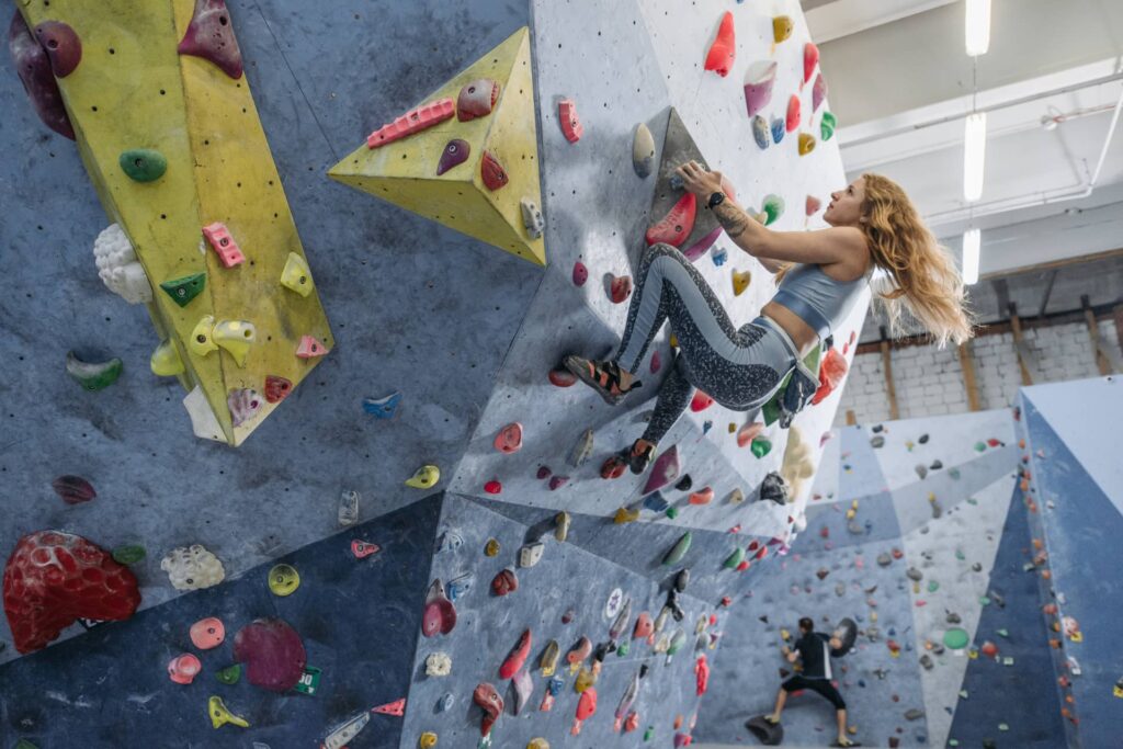 climber hanging on a bouldering wall